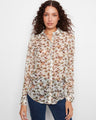 This semi-sheer blouse features a stylish shirt collar and a button-front closure for an elegant look by Charlie B.
