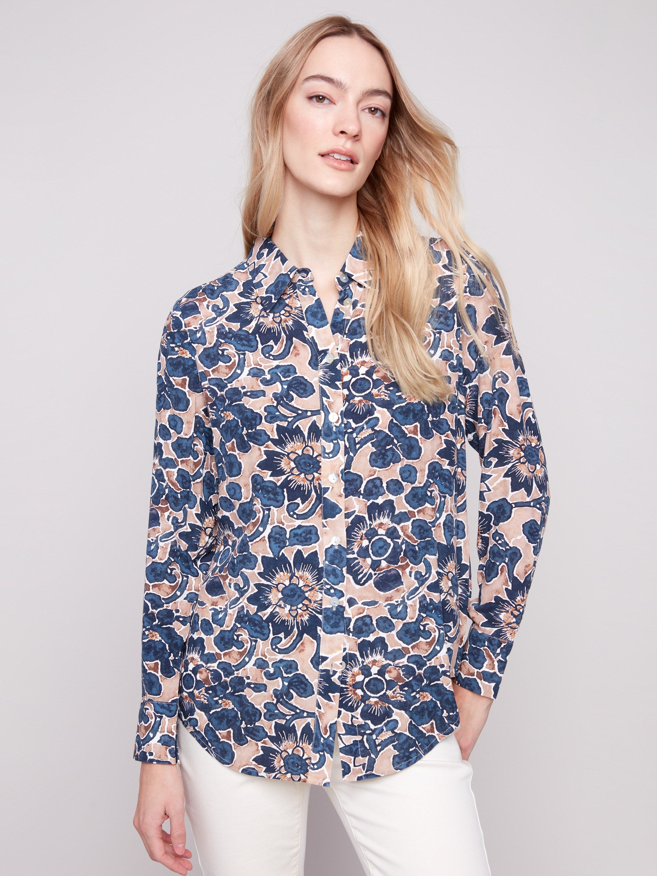 Long sleeve shirt with intricate floral patterns in blue and cream shades, featuring button-down design and foldable cuffs by Charlie B.