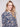 Long sleeve shirt with intricate floral patterns in blue and cream shades, featuring button-down design and foldable cuffs by Charlie B.