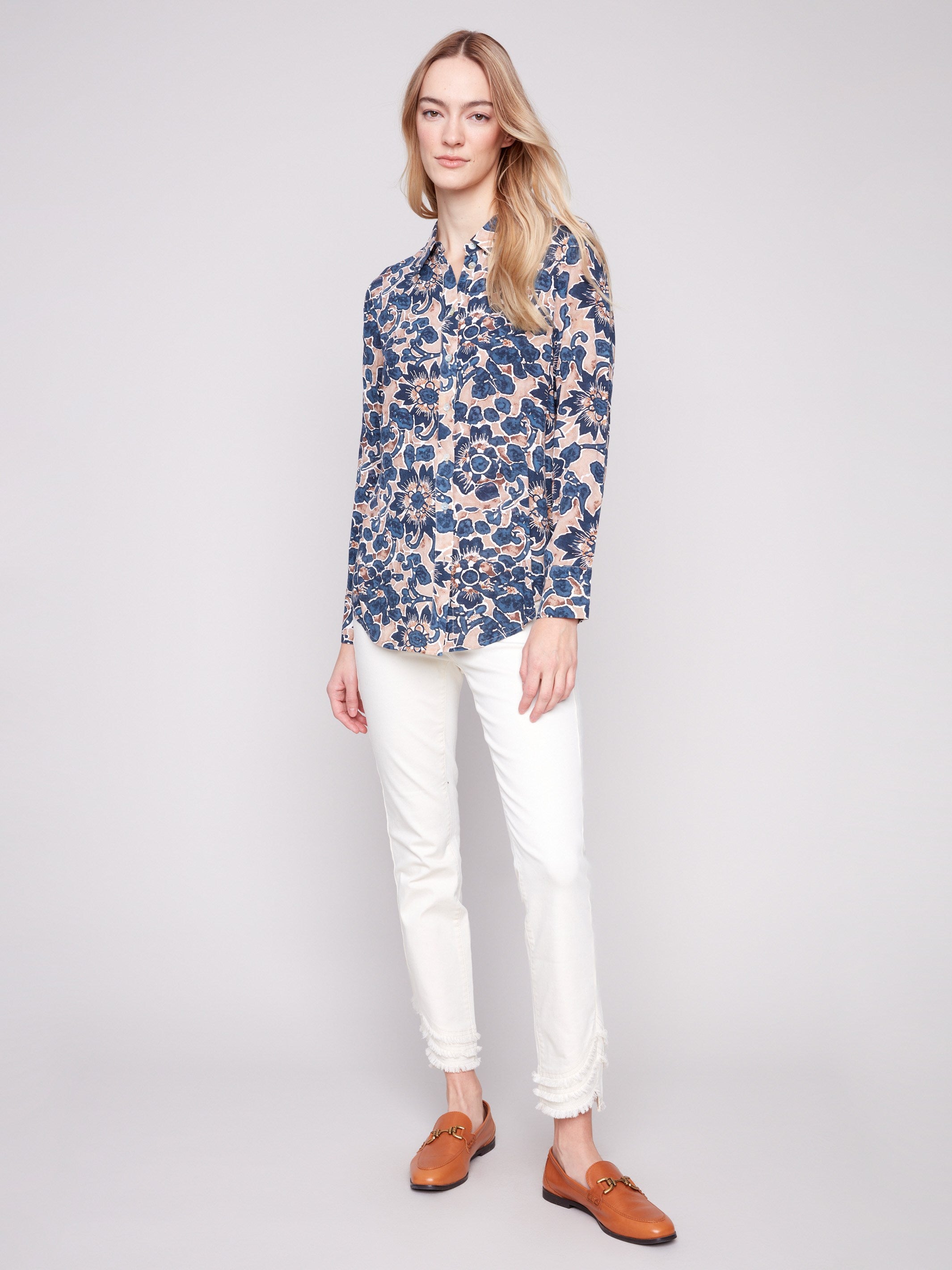 Long sleeve shirt with intricate floral patterns in blue and cream shades, featuring button-down design and foldable cuffs by Charlie B.