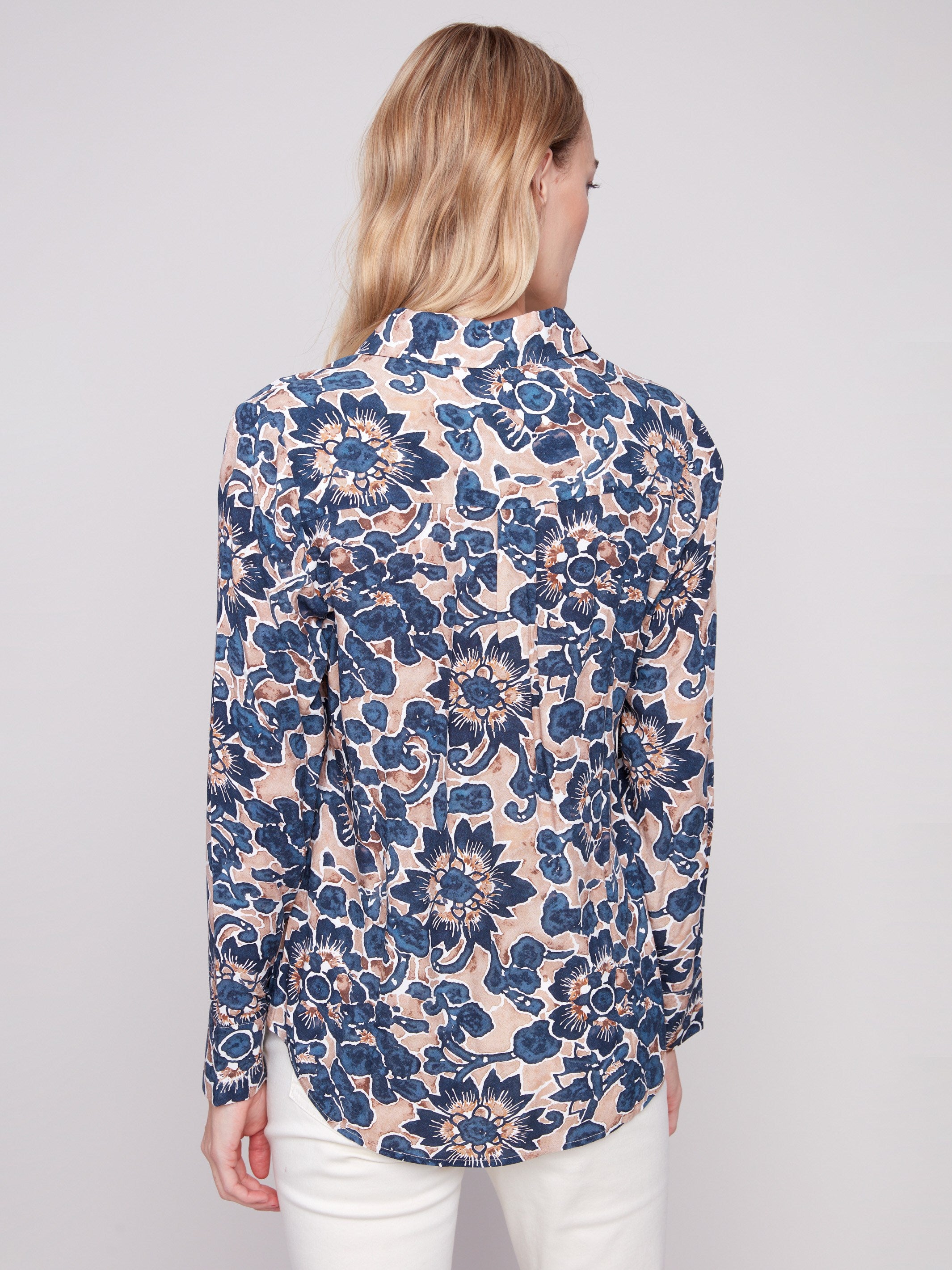 Long sleeve shirt with intricate floral patterns in blue and cream shades, featuring button-down design and foldable cuffs by Charlie B.