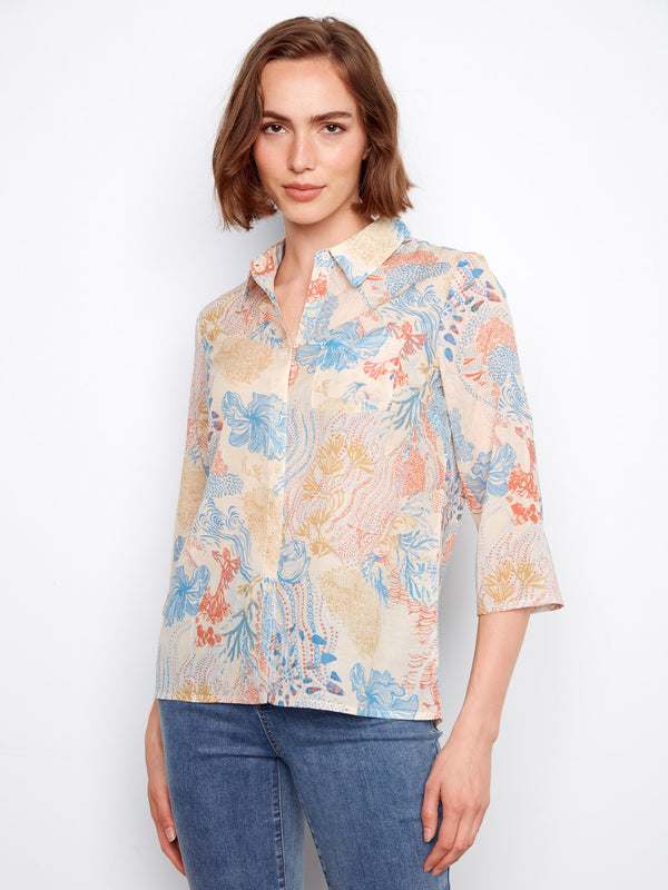 Abstract floral print blouse in pink and navy with button-up style, offering versatility and elegance by Charlie B.