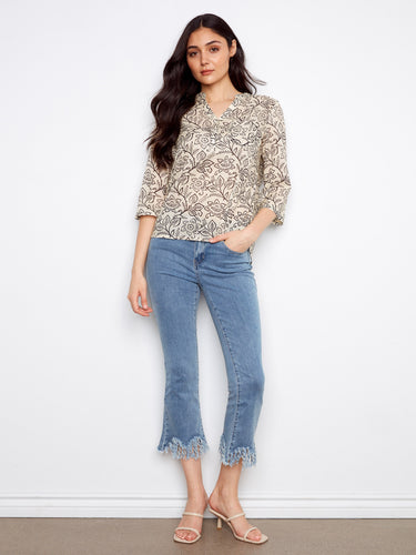 Stylish Henley neckline on this floral blouse adds elegance to any outfit, making it a versatile choice for any occasion by Charlie B.