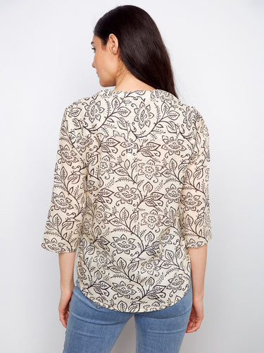 Enjoy the practicality of adjustable roll-up sleeves on this floral blouse, combining fashion with functionality effortlessly by Charlie B.