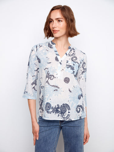 Half-button design on this floral blouse offers versatile styling options, enhancing any casual outfit effortlessly. By Charlie B.
