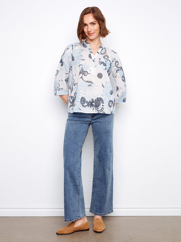 This chic floral blouse features a half-button front and pairs beautifully with straight-leg jeans for timeless style. By Charlie B.