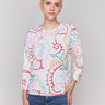 White cotton sweater with a round neckline and abstract multicolor print by Charlie B.