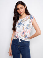 Floral top with a crew neckline and cap sleeves, featuring a charming front tie knot made from 100% cotton by Charlie B.