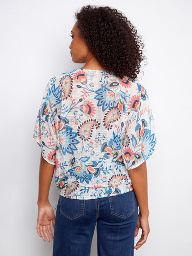 Enhance your outfit with this floral top's side tie at the hem, adding a touch of uniqueness to your wardrobe. By Charlie B.