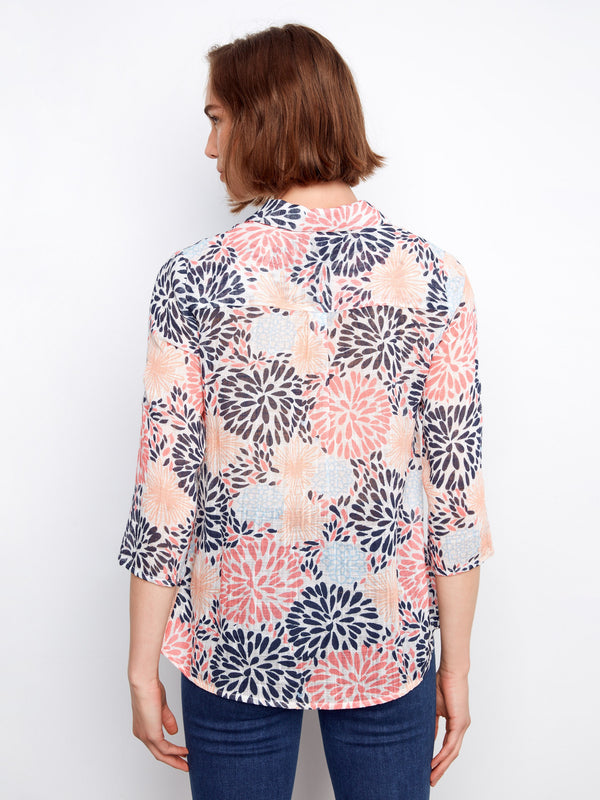 Back view of the floral shirt showcasing its elegant shirt collar and flowing design. By Charlie B.