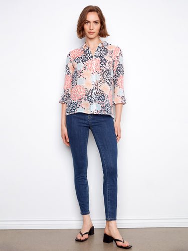 Chic floral top designed with a convenient chest pocket for added functionality. By Charlie B.