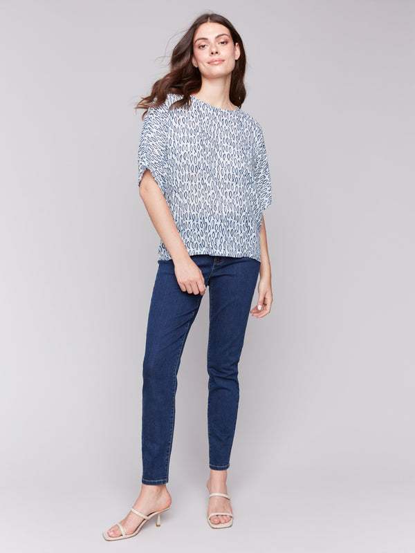 Blue blouse featuring short dolman sleeves and abstract fish design by Charlie B.