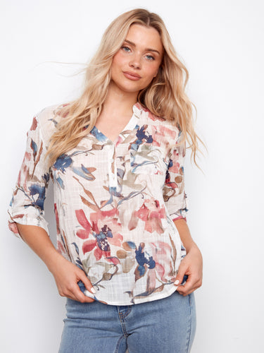 Chic floral blouse with half-button design, perfect for versatile styling in any season by Charlie B.