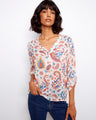 Floral blouse with a Henley neckline and vibrant paisley print, perfect for casual outings. Designed by Charlie B.