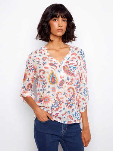 Chic top with a convenient chest pocket, showcasing an eye-catching design suitable for any occasion. Crafted by Charlie B.