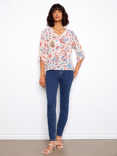 Elegant blouse with adjustable roll-up sleeves and intricate patterns, offering both style and comfort. Created by Charlie B.
