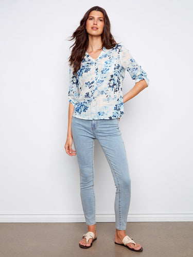 Elegant top with adjustable roll-up sleeves, perfect for adapting to any weather while staying stylish in floral print. By Charlie B.