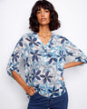 Women's blouse with a floral pattern and chest pocket, showcasing a stylish Henley neckline by Charlie B.