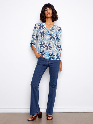 Chic women's blouse featuring adjustable roll-up sleeves and a vibrant floral design by Charlie B.