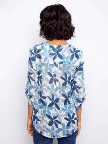 Trendy women's top featuring half-button design and eye-catching floral print by Charlie B.