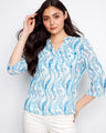 Blue patterned top featuring a stylish Henley neckline and a half-button design, perfect for casual outings. By Charlie B.