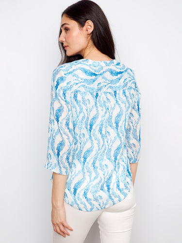 Lightweight blue shirt showcasing a unique pattern and comfortable fit, ideal for relaxed days. By Charlie B.