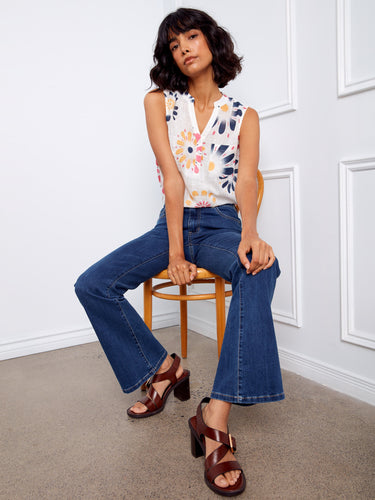 Casual yet stylish floral blouse with a Henley neckline and half-button front, perfect for layering or wearing alone. By Charlie B.