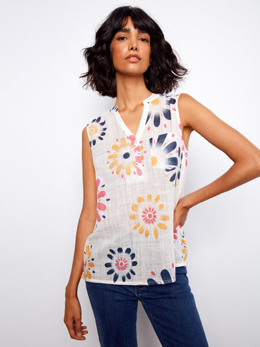Bright floral sleeveless top featuring a handy chest pocket, offering both style and functionality for any occasion. By Charlie B.