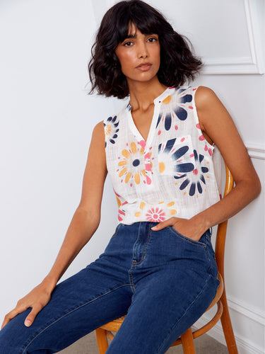 Versatile floral print blouse with Henley neckline, designed to keep you cool in warmer weather while looking trendy. By Charlie B.