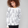 White sweater with black cheetah print showcasing a stylish crew neck design, perfect for casual outings by Charlie B.