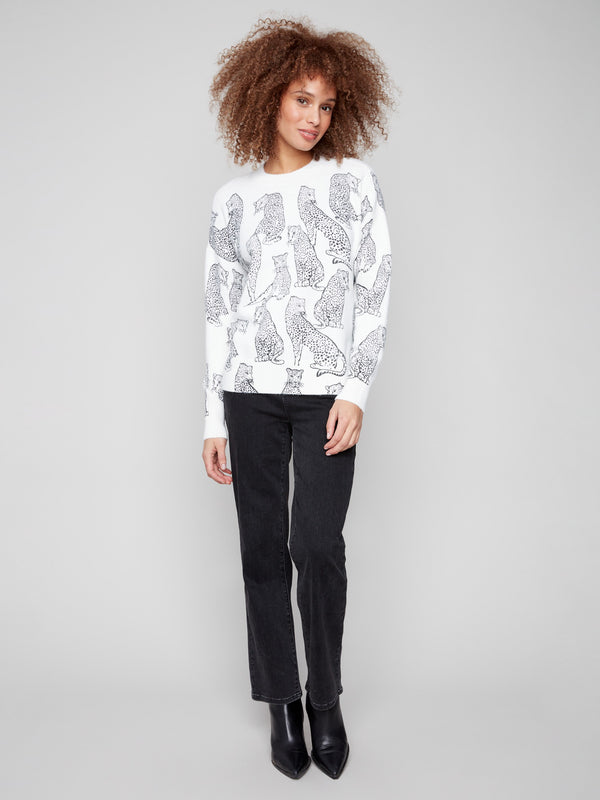 This white sweater features a black cheetah print and a trendy drop shoulder design, adding flair to your wardrobe by Charlie B.