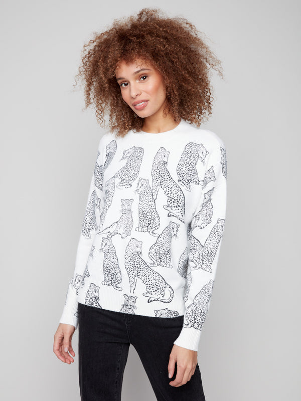 Elegant white sweater adorned with black cheetah print, complete with ribbed hemline and cuffs for added comfort by Charlie B.