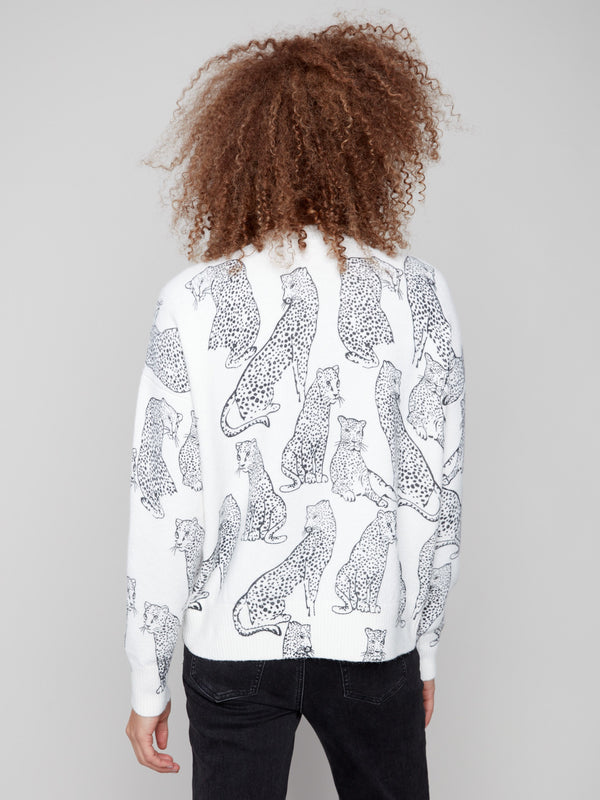 Chic white sweater displaying black cheetah patterns and crafted with attention to detail, offering timeless style by Charlie B.