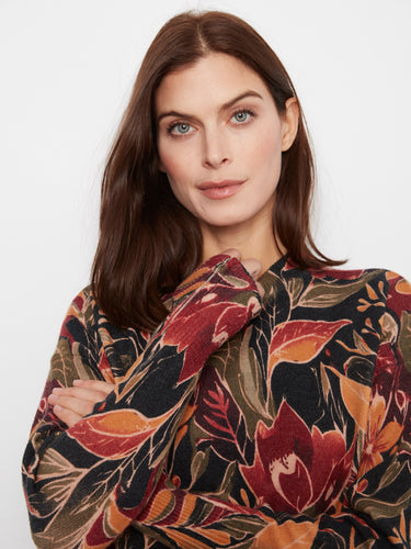 A close-up of the floral pattern on this sweater, showcasing its intricate zippered cuffs. By Charlie B.