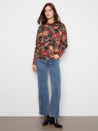Full view of the outfit including the vibrant floral top paired with jeans, emphasizing casual elegance by Charlie B.