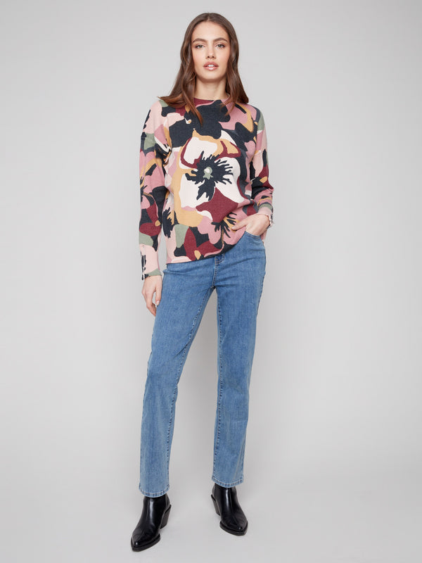 This crew neck sweater showcases an artistic floral pattern with dolman sleeves by Charlie B.