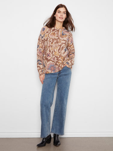 Floral sweater in beige with brown and blue accents, showcasing zippered cuffs for added style by Charlie B.