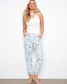 Floral print pants with a slim fit, featuring an elastic waistband and drawstring for comfort. Two side pockets add functionality by Charlie B.