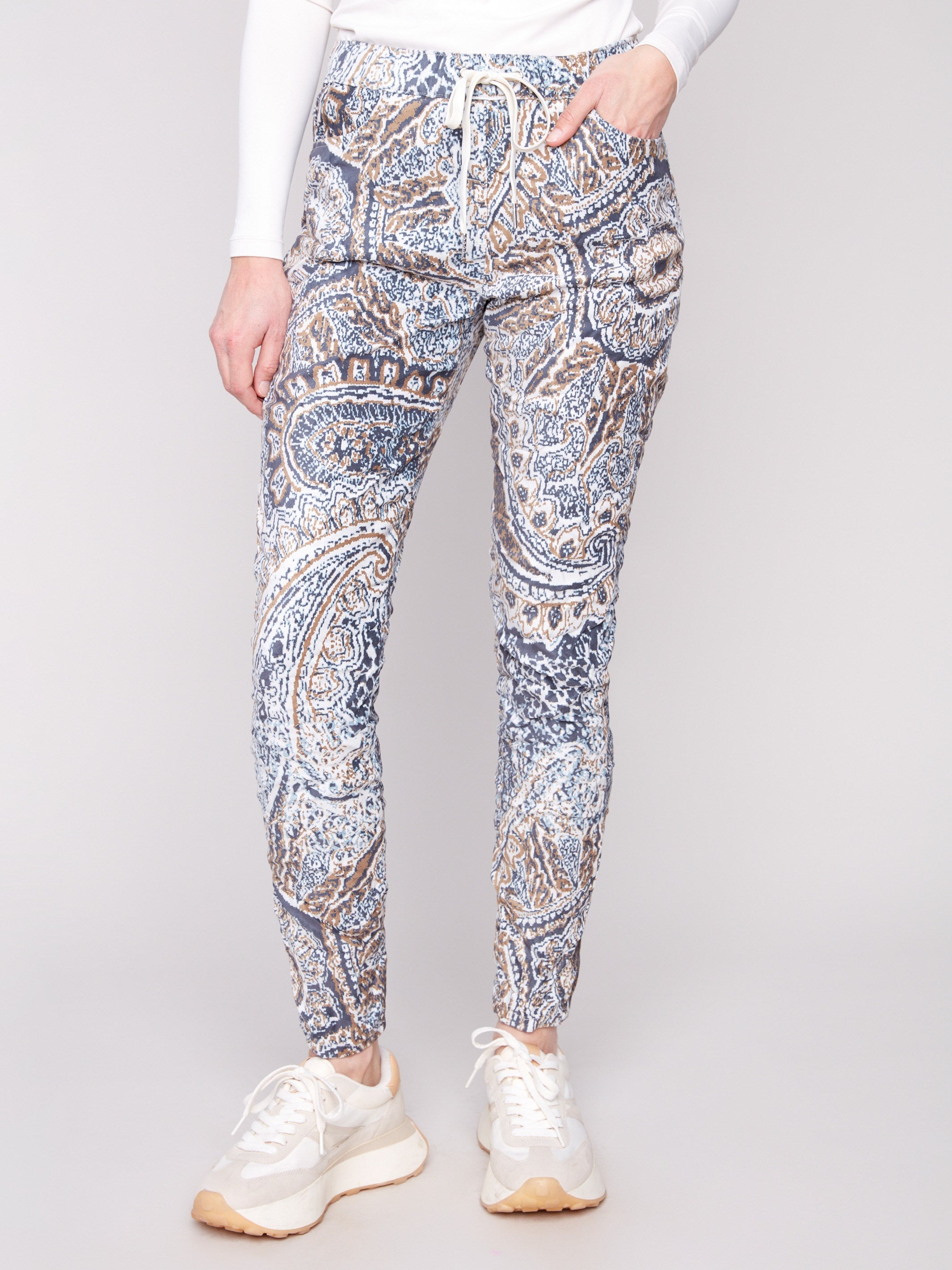 These jogger pants feature an elastic waistband with drawstring, offering both style and functionality by Charlie B.