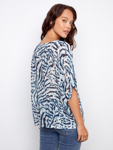 The bold pattern on this versatile piece adds an eye-catching element to any wardrobe. By Charlie B.