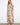 This vibrant dress features a V-neckline, adding elegance to the colorful pattern. Perfect for any occasion. By Charlie B.