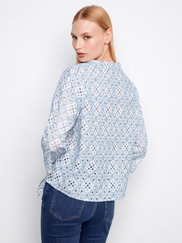 Elegant blue eyelet blouse showcasing exquisite embroidery and versatile design in breathable cotton fabric by Charlie B.