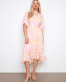 Elegant dress featuring a V-neckline and self-tie belt, perfect for any occasion. Designed by Charlie B.