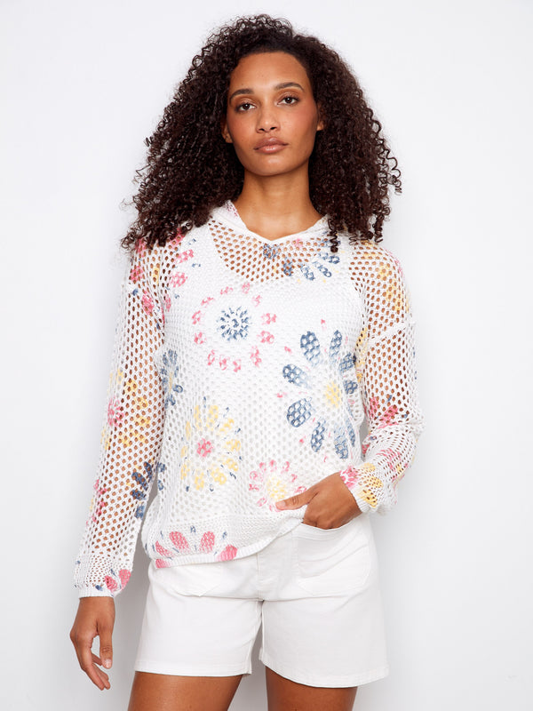 Vibrant fishnet crochet top with floral patterns, perfect for casual outings. Style it effortlessly with your favorite shorts. By Charlie B.