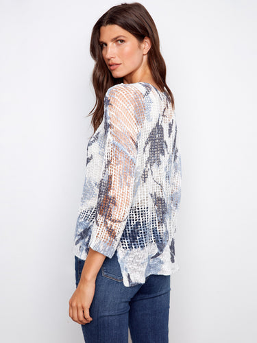 Chic 3/4 sleeve fishnet sweater with slit hem and abstract design, offering comfort and style by Charlie B.