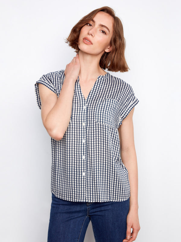 Navy gingham blouse featuring a V-neck with stand collar, button-up design, and chest pockets by Charlie B.