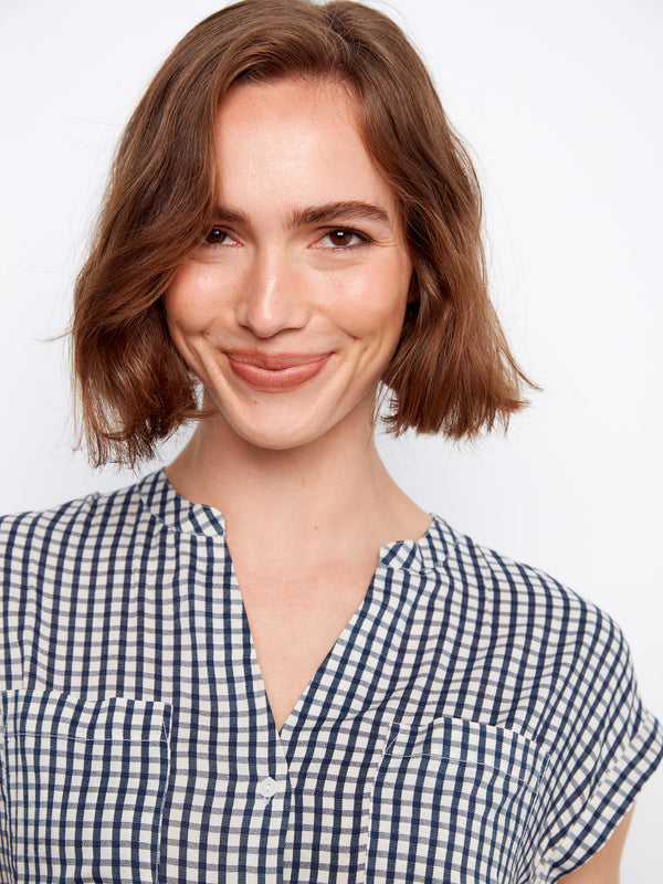 Stylish navy gingham top adorned with practical chest pockets and elegant detailing by Charlie B.