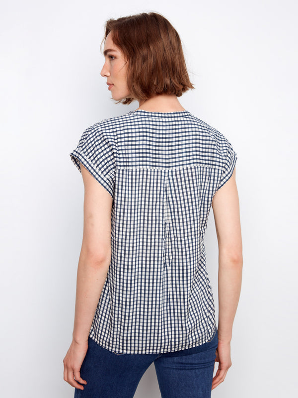 Comfortable navy gingham shirt showcasing cap sleeves and a modern V-neck design by Charlie B.