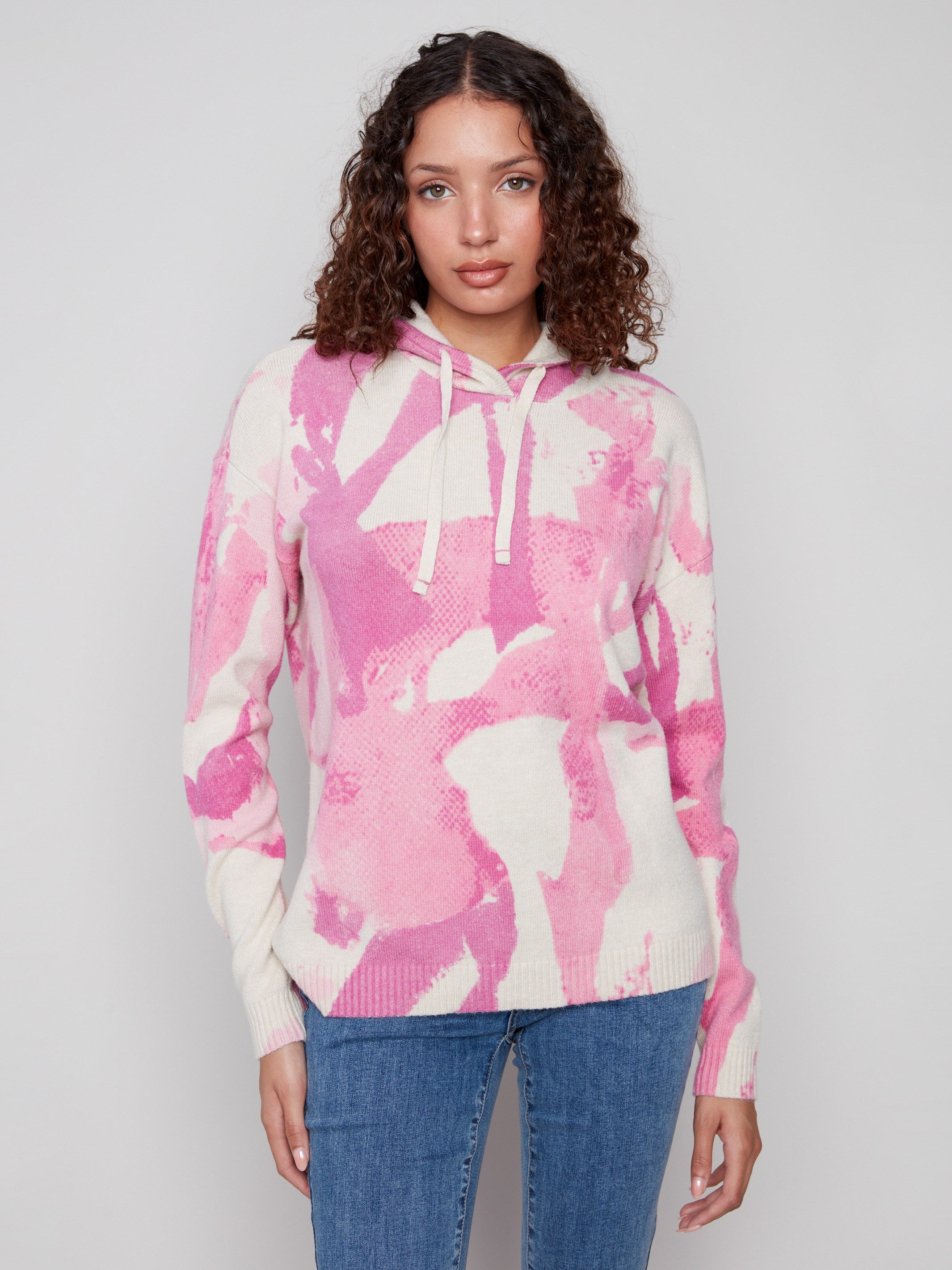 Pink abstract printed hoodie sweater featuring a hood with drawstrings, adding style and function by Charlie B.
