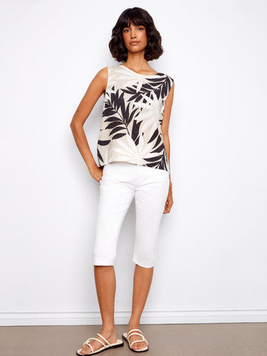 Chic sleeveless top featuring back button detail, adding flair to the tropical design. Ideal for summer wear. By Charlie B.